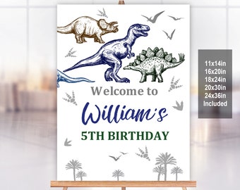 May include: A white welcome sign with a blue dinosaur, a brown dinosaur, and a green dinosaur. The sign says "Welcome to William's 5th Birthday". The sign is available in sizes 11x14in, 16x20in, 18x24in, 20x30in, and 24x36in.