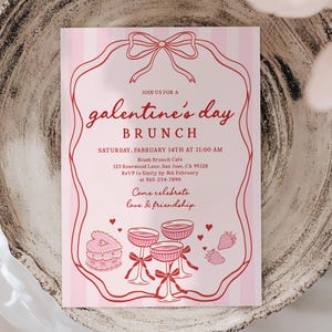 May include: A pink Galentine's Day brunch invitation with a red decorative border and text. The invitation includes the date, time, location, and RSVP information. The design features illustrations of champagne glasses, cake, strawberries, and hearts.