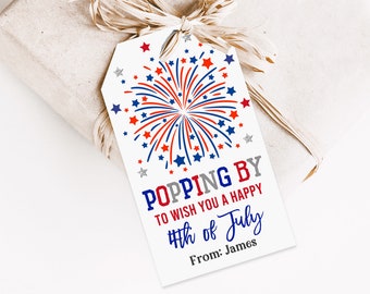 May include: A white gift tag with a red, white and blue firework design. The text reads "Popping By to wish you a Happy 4th of July" and "From: James".