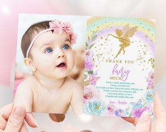 May include: Thank you card with a photo of a baby girl wearing a pink headband and flowers. The card has a rainbow, a fairy, and flowers with gold glitter accents. The text on the card reads "Thank you fairy much".