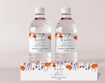 May include: Two clear plastic water bottles with labels that say "Baby in Bloom" and "Stephanie's baby shower" with a floral design. A matching label with the same text is shown below the bottles.