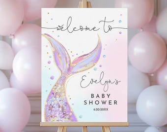 May include: A pink and blue welcome sign for a baby shower with a watercolor mermaid tail design. The sign says "Welcome to Evelyn's Baby Shower 6.20.20XX".