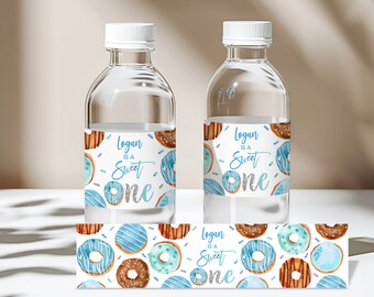 May include: Water bottle labels with a donut theme. The labels feature blue and brown donuts with sprinkles and the text "Logan is a Sweet One".