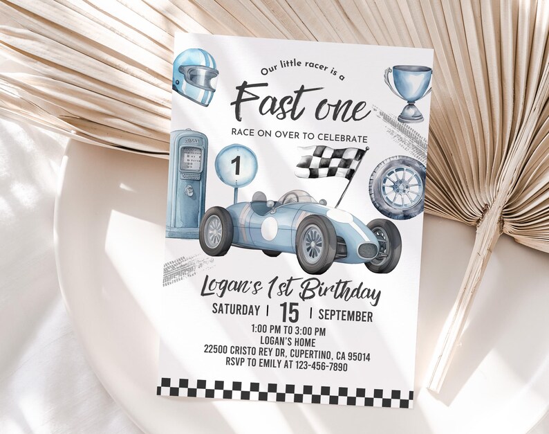 May include: A blue and white race car birthday invitation with a checkered flag, a trophy, a gas pump, and a racing helmet. The text reads "Our little racer is a Fast one Race on over to celebrate Logan's 1st Birthday Saturday | 15 | September 1:00 PM to 3:00 PM Logan's Home 22500 CRISTO REY DR, CUPERTINO, CA 95014 RSVP to EMILY at 123-456-7890"