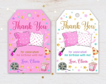 May include: Two pink and white thank you tags with a sleepover theme. The tags feature pillows, pizza, popcorn, nail polish, and a film reel. The text on the tags reads "Thank You for celebrating my birthday with me! Love, Olivia."