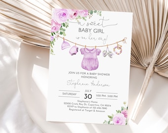 May include: A purple baby shower invitation with a watercolor floral design. The invitation says "a sweet baby girl is on her way!" and includes details about the shower, including the date, time, and location.