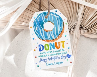 Può includere: Un biglietto bianco con un'illustrazione di una ciambella blu e arancione. Il biglietto dice "DONUT know what I would do without a friend like you! Happy Valentine's Day! Love, Logan".