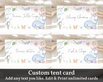 May include: Set of four printable tent cards featuring a watercolor illustration of a whale, seahorse, and other sea creatures. The cards have the text "Ocean Jello Cups", "Shrimp Skewers", "Ocean Water", and "Fish & Chips".