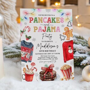 May include: A festive invitation for a Pancakes and Pajama Party, featuring colorful text and illustrations of holiday sweaters, gingerbread men, and treats. The invitation is for a 10th birthday celebration.