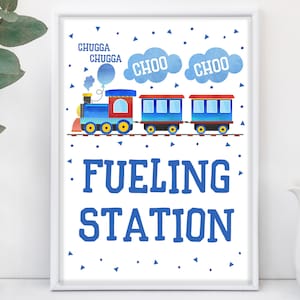 May include: A blue and red train with a white smoke cloud that says "Choo Choo" and a sign that says "Fueling Station".