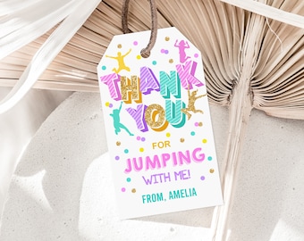 May include: A white thank you tag with colorful text that says "Thank You for Jumping with Me! From, Amelia". The tag has a pink, purple, and blue color scheme with gold glitter accents. There are small colorful dots and stick figures jumping on the tag.