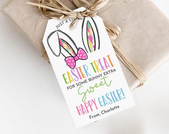 以下が含まれることがあります： カラフルなウサギの耳と「JUST A LITTLE EASTER TREAT FOR SOME BUNNY EXTRA SWEET HAPPY EASTER! From, Charlotte」というテキストが書かれた白いギフトタグ。