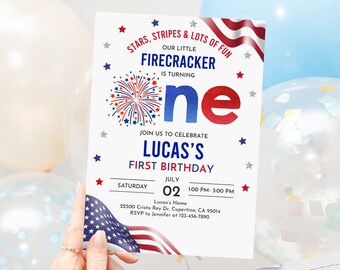 May include: A red, white, and blue invitation for a first birthday party. The invitation features a firework design and the text "Stars, Stripes & Lots of Fun. Our Little Firecracker is Turning One. Join us to Celebrate Lucas's First Birthday. Saturday, July 02, 1:00 PM - 3:00 PM. Lucas's Home, 22500 Cristo Rey Dr, Cupertino, CA 95014. RSVP to Jennifer at 123-456-7890."