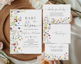 May include: A baby shower invitation suite with a floral design. The invitation reads "Baby in Bloom" and includes event details. Additional cards include "Books for Baby," "Thank You," and a "Diaper Raffle" card. The suite features butterflies and colorful flowers.
