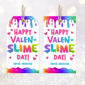 May include: Two white gift tags with a colorful rainbow design. The tags read "Happy Valen-Slime Day!" in pink, blue, and green, with the text "From. Madison" at the bottom. Each tag has a twine string for hanging.