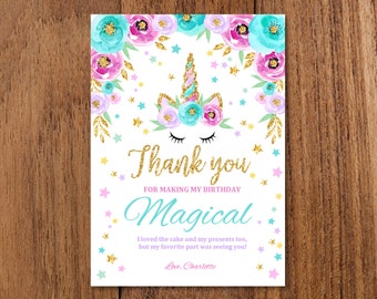 May include: A unicorn thank you card with a watercolor floral design in shades of pink, teal, and purple. The card features gold glitter accents and the text "Thank you for making my birthday magical. I loved the cake and my presents too, but my favorite part was seeing you! Love, Charlotte."