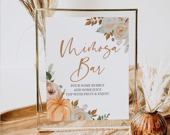 May include: A Mimosa Bar sign in a gold frame, featuring watercolor floral and pumpkin accents. The sign includes the text "Mimosa Bar" in elegant script, with instructions below. Perfect for a fall-themed event.