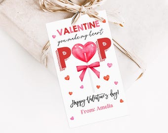 May include: Valentine's Day gift tag featuring a red heart lollipop and the text "Valentine you make my heart POP Happy Valentine's Day! From: Amelia"