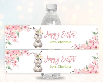 May include: Two printable water bottle labels with a pink floral design and a bunny illustration. The text on the label reads "Happy Easter" and "Love, Charlotte".
