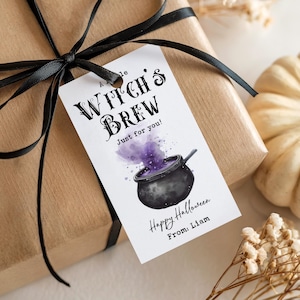 May include: A white rectangular gift tag tied with a black ribbon, featuring the text A little WITCH'S BREW Just for you! Happy Halloween From: Liam and a watercolour illustration of a black cauldron with purple smoke rising from it.