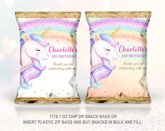 May include: Two white chip bags with a unicorn design. The bags have a rainbow and gold glitter design. The text on the bags reads "Charlotte's 3rd Birthday" and "Thank you for celebrating with me".