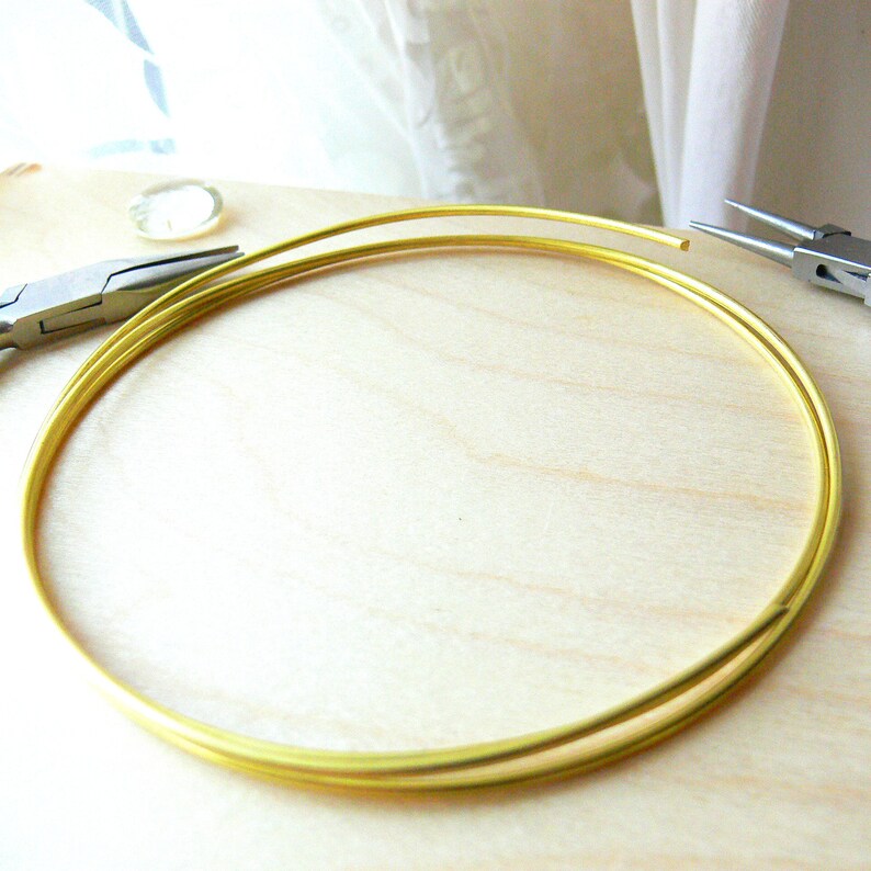 May include: A close-up of a gold wire circle, likely used for jewellery making. The wire is coiled and ready to be shaped.
