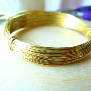 May include: A spool of gold-colored wire, wound tightly in a coil.