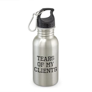 May include: A stainless steel water bottle with a black cap and a silver carabiner clip. The bottle has the text "TEARS OF MY CLIENTS" printed in black, centered on the front. The bottle is designed for carrying water or other beverages.