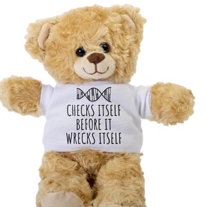 May include: A brown teddy bear wearing a white t-shirt with a DNA strand graphic and the text "Checks itself before it wrecks itself".