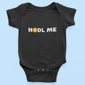 May include: Black baby grow with white text that says "HODL ME" and a yellow Bitcoin symbol.