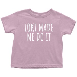 Op de afbeelding: Een lichtpaarse t-shirt met korte mouwen met de tekst "Loki Made Me Do It" in wit.