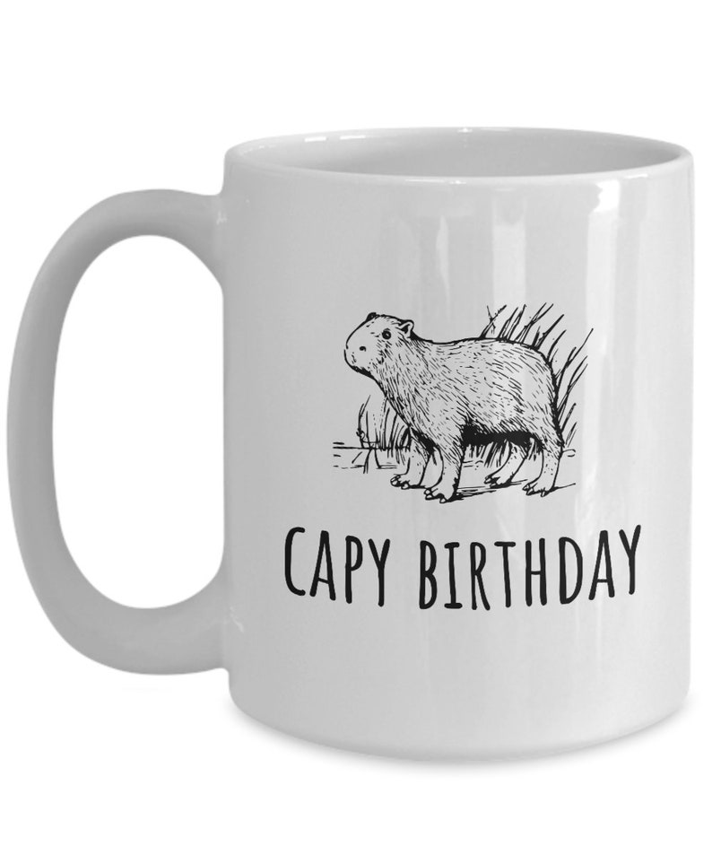 May include: White ceramic coffee mug with a black line drawing of a capybara and the text "CAPY BIRTHDAY".