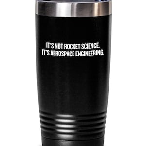 May include: Black stainless steel tumbler with a white inscription that reads "It's not rocket science. It's aerospace engineering."