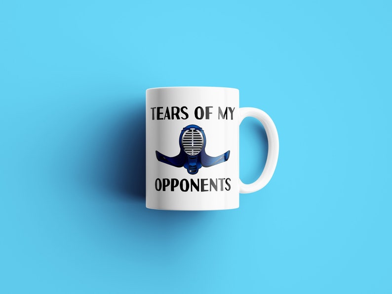 May include: White ceramic mug with a black and blue illustration of a fencing mask and the text "Tears of my opponents".