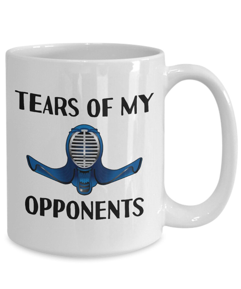 May include: White ceramic coffee mug with black text that reads "Tears of my opponents" and a blue and silver illustration of a kendo helmet.