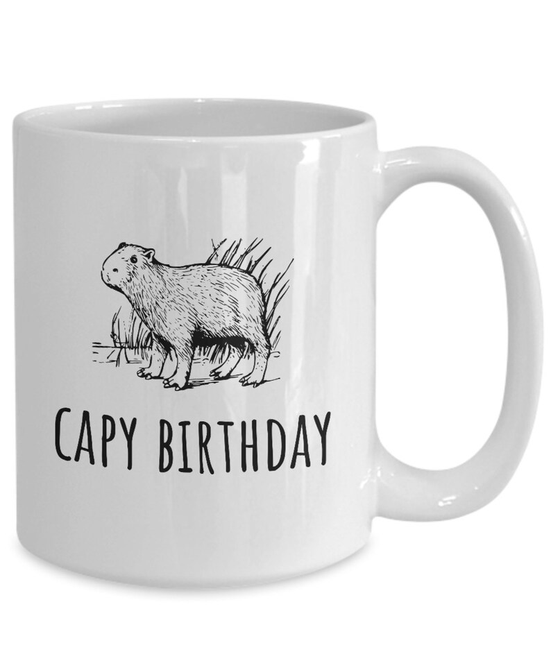 May include: White ceramic coffee mug with a black line drawing of a capybara and the text "CAPY BIRTHDAY".