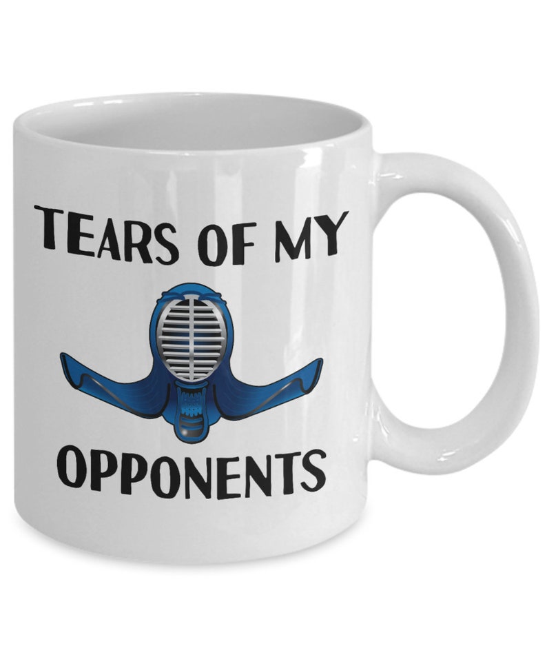 May include: White ceramic coffee mug with the text "Tears of my opponents" and a blue and silver kendo mask illustration.