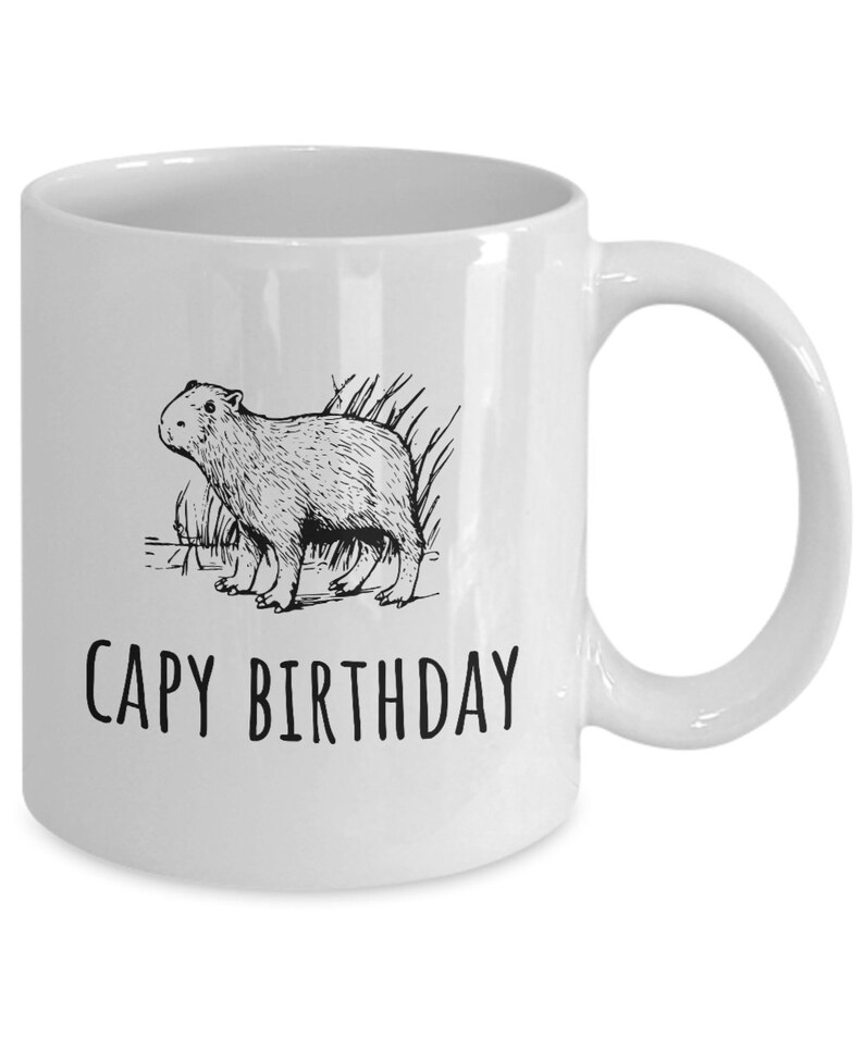 May include: White ceramic coffee mug with a black line drawing of a capybara and the text "CAPY BIRTHDAY".
