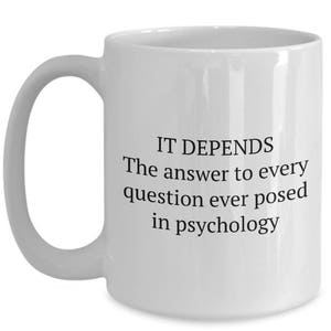 May include: White ceramic coffee mug with a black text design that reads "IT DEPENDS The answer to every question ever posed in psychology".