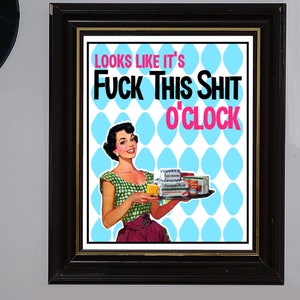 May include: A framed print with a retro-style illustration of a woman holding a tray of groceries. The text on the print reads "Looks like it's Fuck This Shit o'clock".
