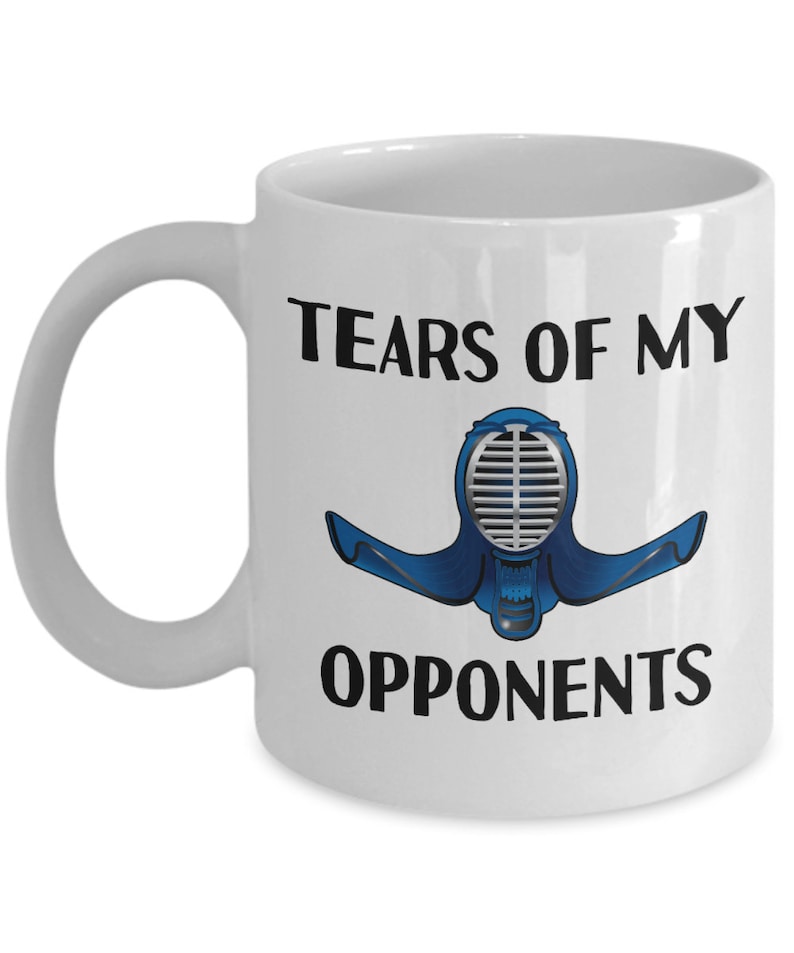 May include: White ceramic coffee mug with a black graphic of a kendo mask and the text "Tears of my opponents".