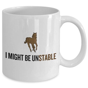 May include: White ceramic mug with a brown cartoon horse running and the text "I might be unstable" printed in black.