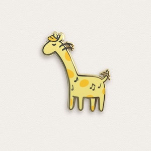 May include: A gold-colored enamel pin featuring a cartoon giraffe with yellow spots and musical notes. The giraffe has a closed eye and a small flower on its head.