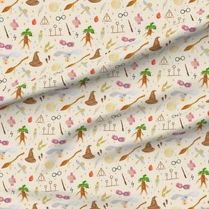 May include: A cream-colored fabric featuring a repeating pattern of magical icons including brown sorting hats, white owls, broomsticks, mandrakes, golden snitches, round glasses, lightning bolts, pink spectacles, and triangular symbols.