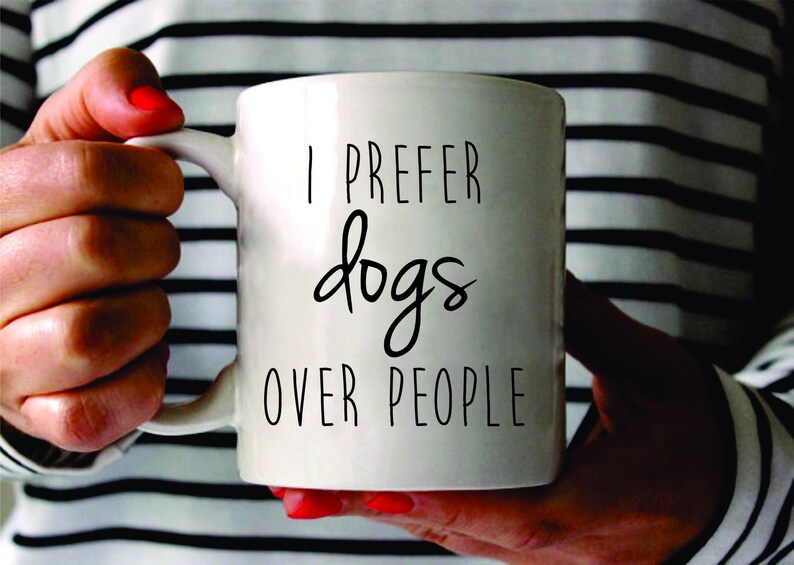 May include: White ceramic mug with black text that reads "I prefer dogs over people".