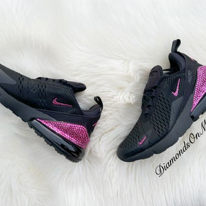 May include: Black Nike Air Max 270 sneakers with pink rhinestones on the heel and swoosh. The text "Diamonds On My Feet" is on the bottom right corner of the image.