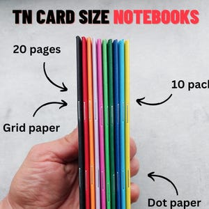 May include: A 10 pack of TN card size notebooks with 20 pages each. The set includes various colours such as black, red, orange, purple, pink, green, blue, and yellow. The notebooks feature grid, dot, and blank paper options with stapled spines.