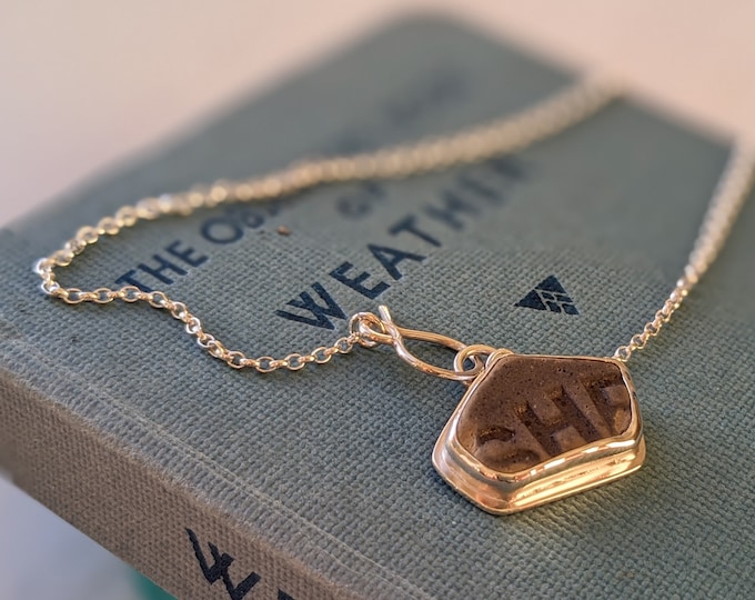 Featured listing image: sea pottery silver pendant necklace featuring the word she