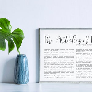 May include: A framed print of "The Articles of Faith of the Church of Jesus Christ of Latter-day Saints" with a white background and black text. The text includes the 13 articles of faith.