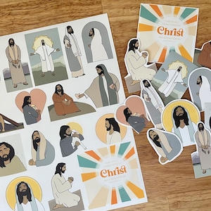 May include: A sheet of stickers featuring illustrations of Jesus Christ in various poses. The stickers are on a wooden surface. The text on the stickers reads "I can do all things through Christ who strengthens me."